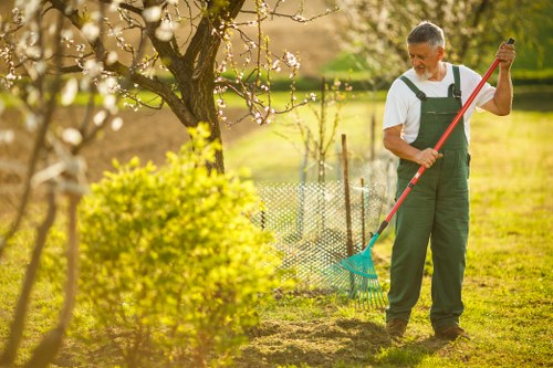 Workers wearing PPE during hedge trimming operations